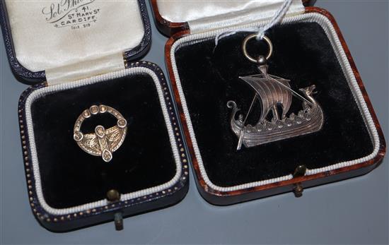 A cased white metal pendant modelled as a Viking ship and a cased gilt white metal Celtic brooch, largest 36mm.